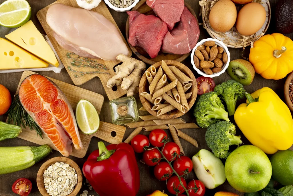 Assorted healthy foods including fruits, vegetables, lean meats, and whole grains that contribute to teeth health, as recommended by Montana Center for Implants and Dentures.