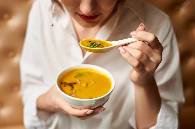 Person eating soft food after bone graft and oral surgery, recommended by Montana Center for Implants and Dentures