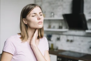Woman experiencing jaw pain after dental implants and oral surgery, seeking relief from Montana Center for Implants and Dentures