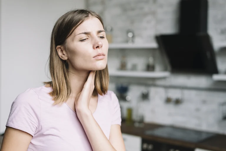 Woman experiencing jaw pain after dental implants and oral surgery, seeking relief from Montana Center for Implants and Dentures