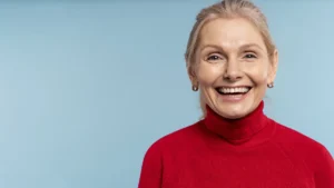 Happy senior woman showcasing her bright smile after a smile makeover with natural-looking dentures from Montana Center for Implants and Dentures.