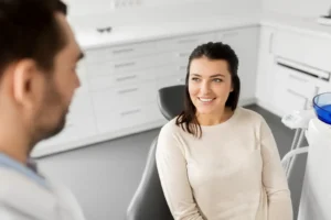 A patient discussing pre-op steps with a dentist at Montana Center for Implants and Dentures, learning how to prepare for dental implant surgery.